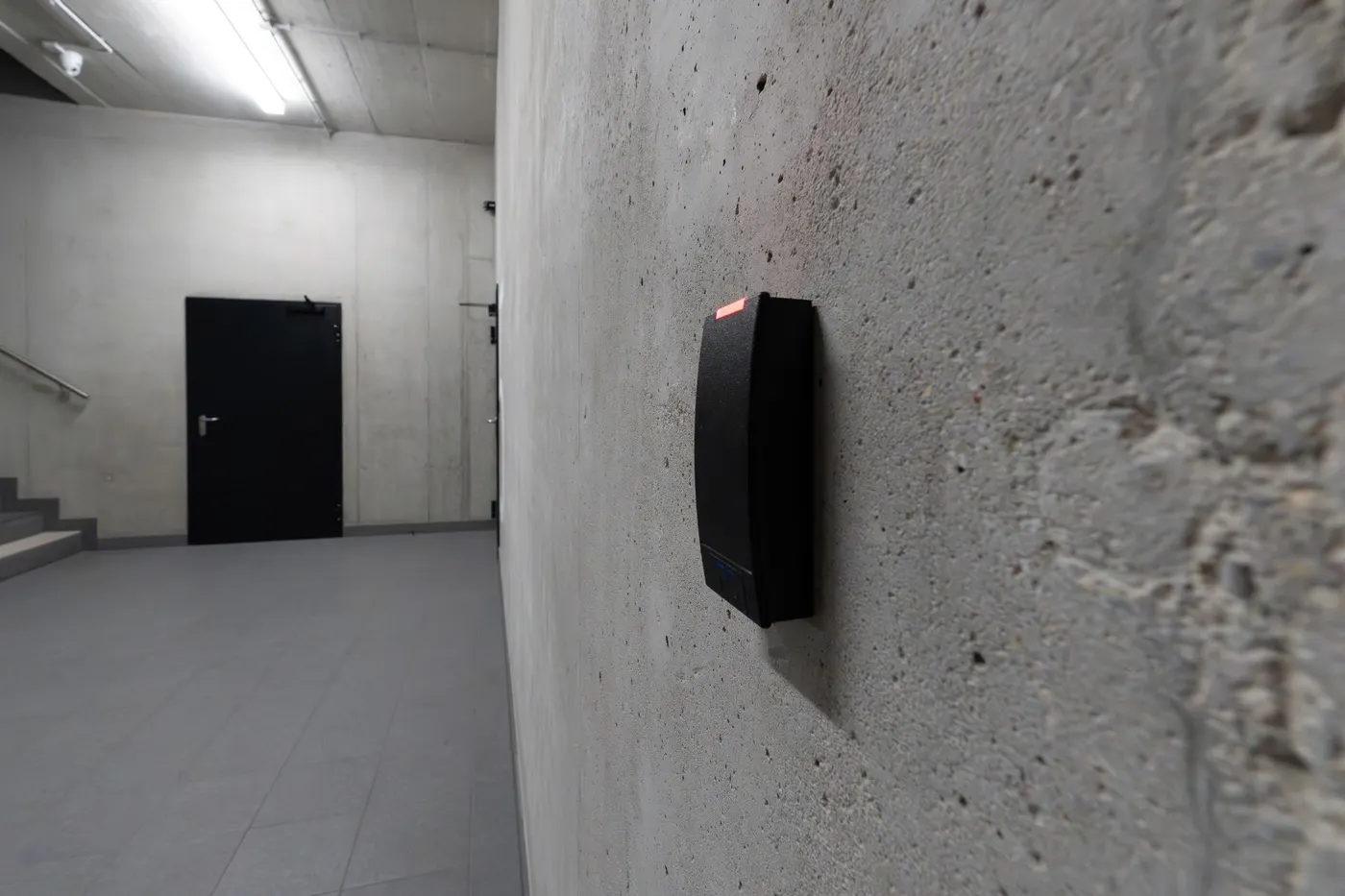 Wall-mounted RFID access reader in a corridor