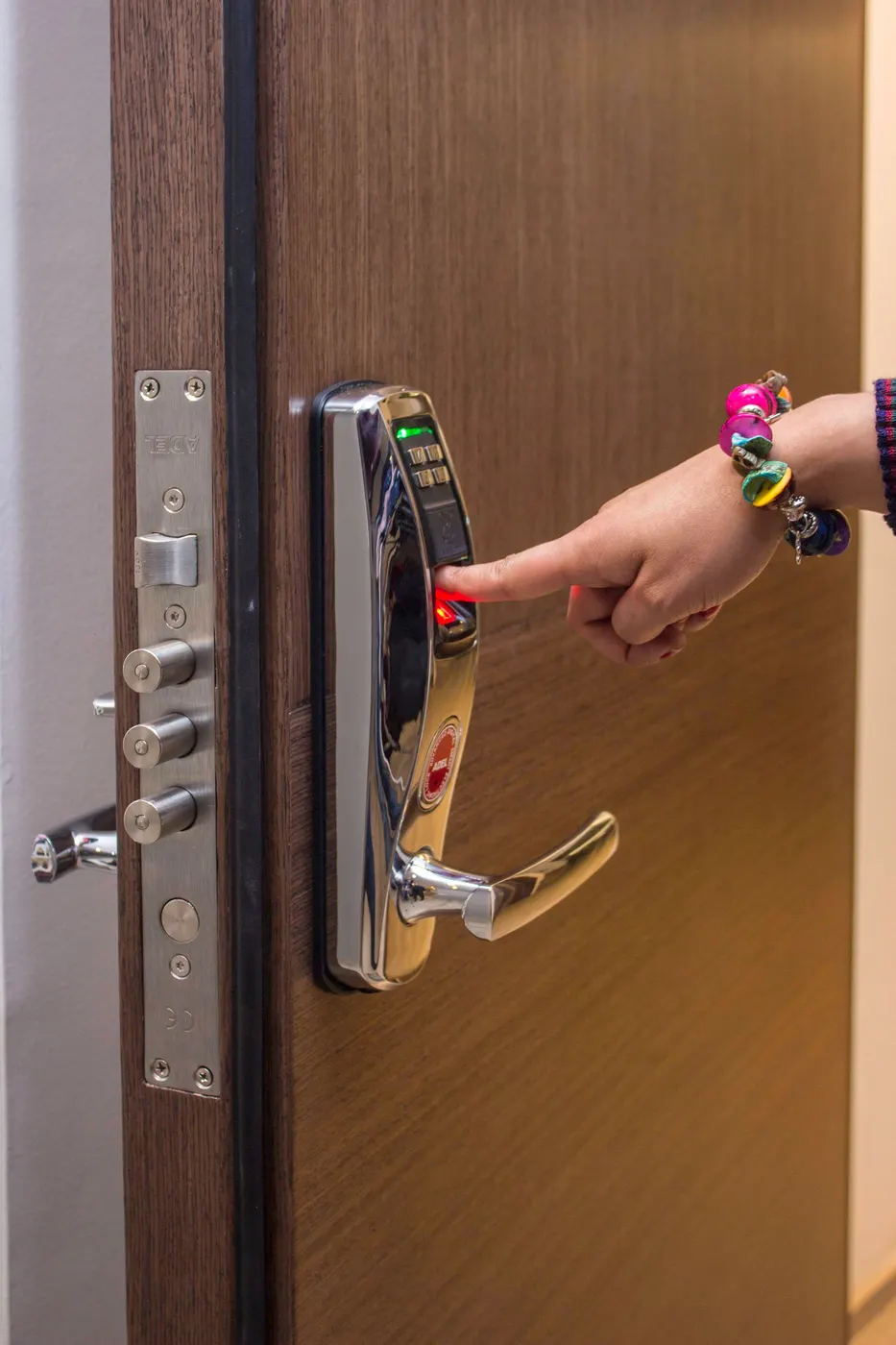 Hand using a fingerprint digital door lock