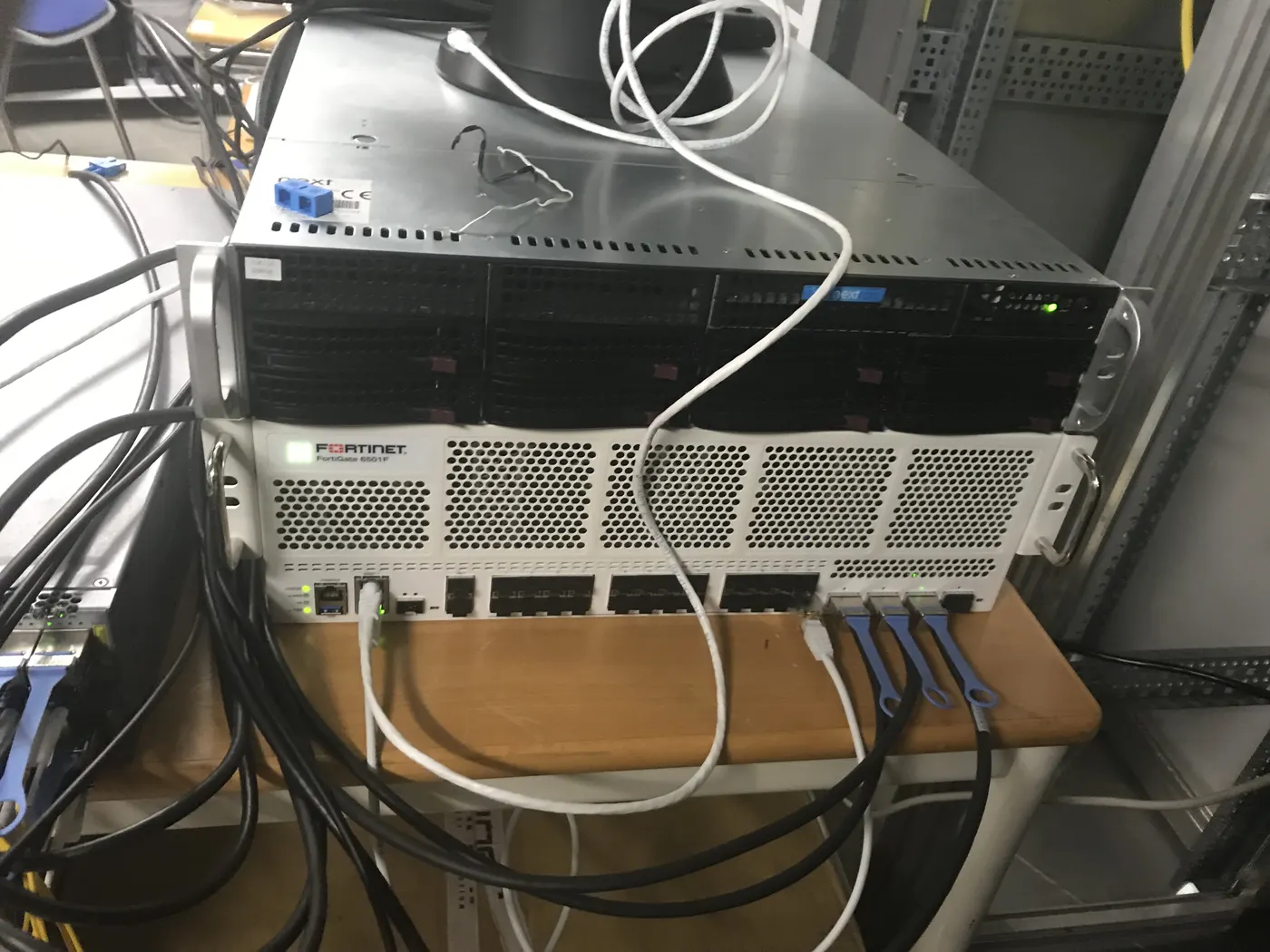 Firewall and server installed in a network rack with cabling