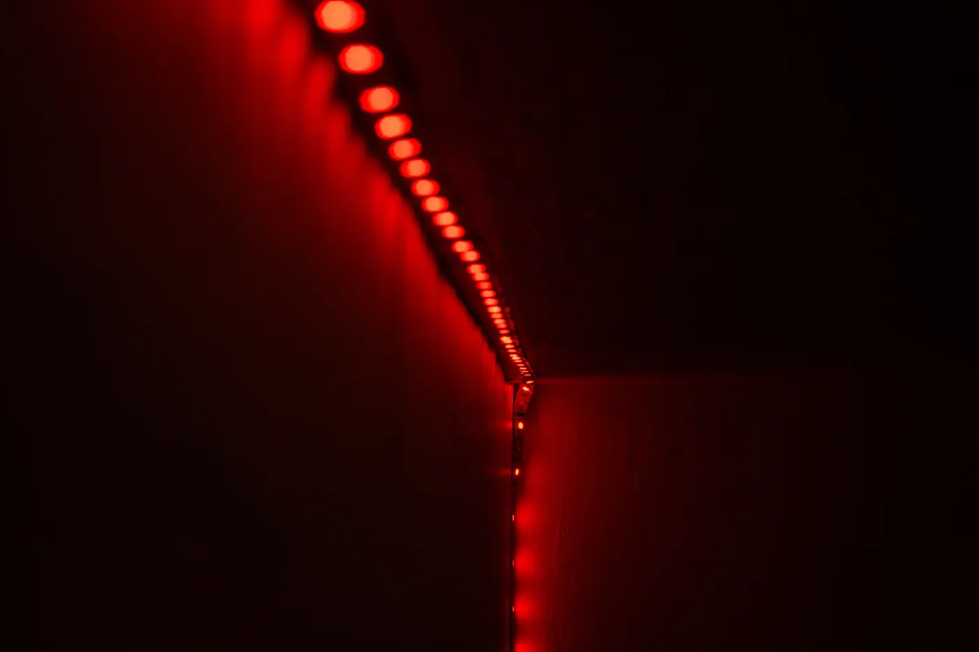 Red LED strip lighting along a wall